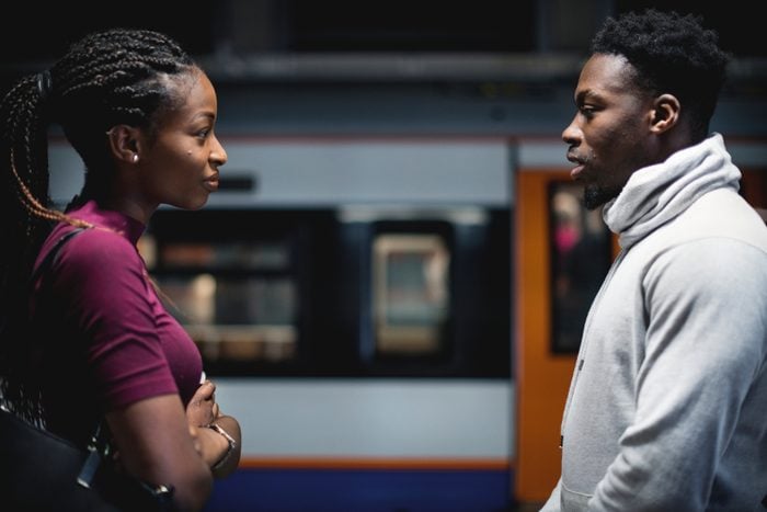 Couple having an argument on the subway platform