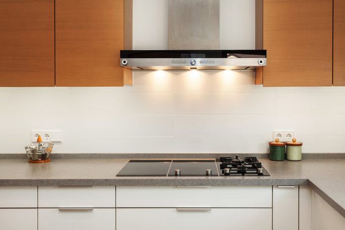 Closeup of exhaust hood and ceramic cooking plate in the new modern kitchen
