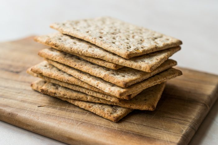Stack of Honey Flavored Graham Crackers on Wooden Surface.