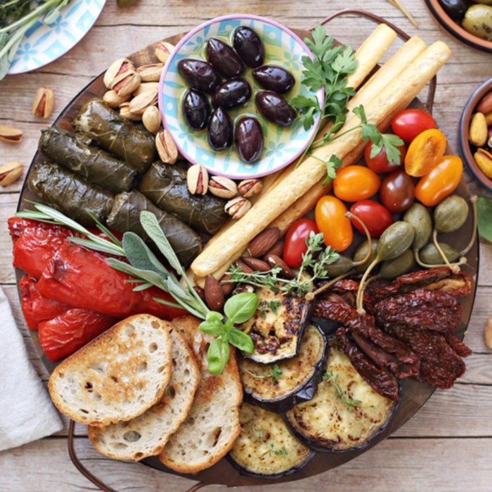 Mediterranean appetizers table concept. Platter with antipasto selection, grilled vegetables, olives, nuts and roasted bread. Overhead view.; Shutterstock ID 1124263523; Job (TFH, TOH, RD, BNB, CWM, CM): TOH