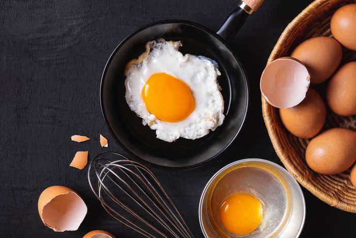 Frying pan in eggs and raw eggs