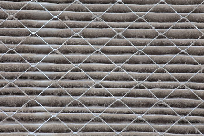 Close up view of a dirty house air filter that needs to be replaced