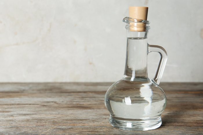 Glass bottle of white vinegar.