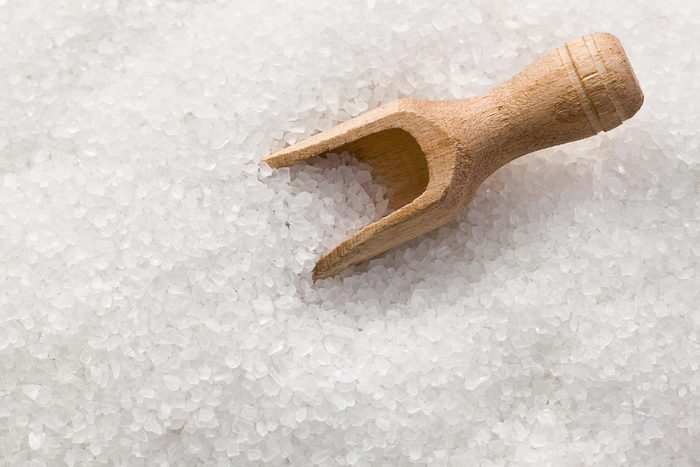 wooden scoop in crystal salt