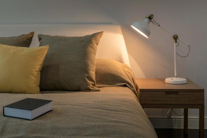 bedside lamp alit next to bed