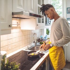 man making breakfast in kitchen