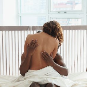 woman and man being intimate in bed