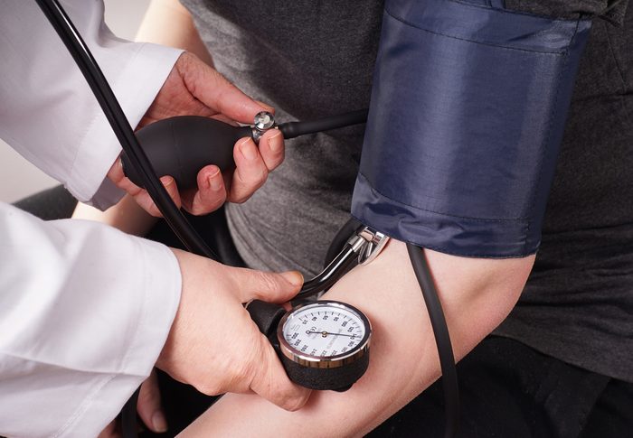Patient gets Blood pressure check up by the Doctor