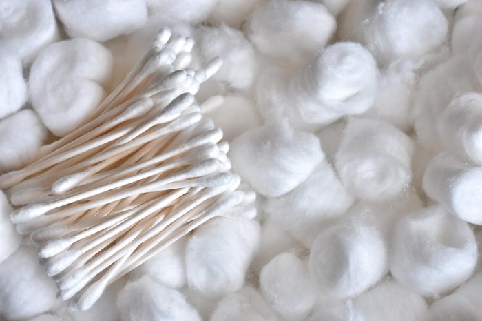 An abstract image of fluffy cotton balls and cotton swabs.