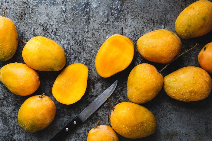Fresh ripe mangoes with knife