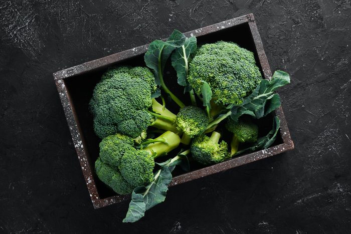 Broccoli. Fresh green broccoli on a black stone table. Top view. Free copy space.