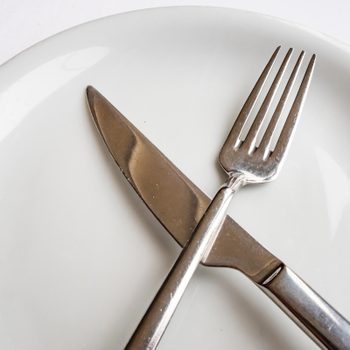 close up fork and knife on plate