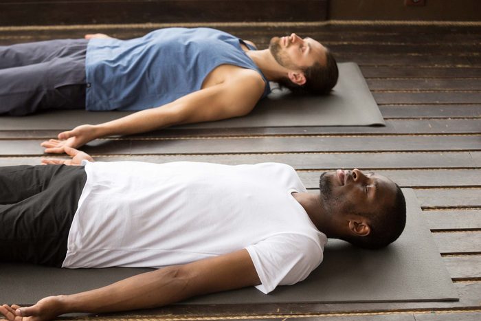 men lying down meditating