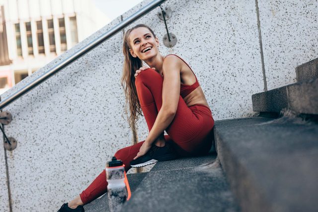 woman taking a break from exercise outside on steps