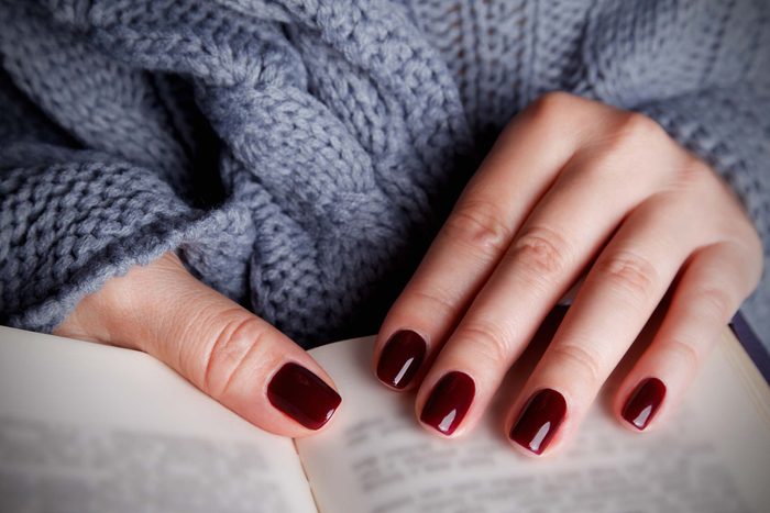 nicely manicured nails with dark red polish