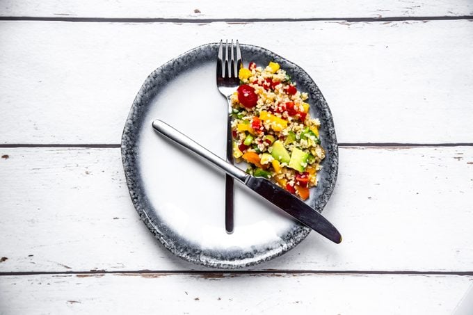 plate with fork and knife resembling a clock for intermittent fasting concept