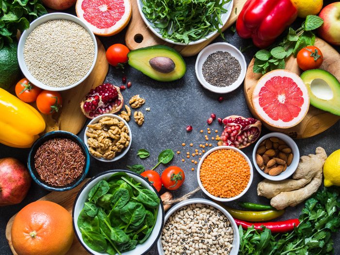 Fresh raw  ingredients for healthy cooking.  Vegetables, fruit, seeds, cereals, beans, spices, superfoods, herbs. Clean food. Top view. Diet or vegetarian food concept. Copy space