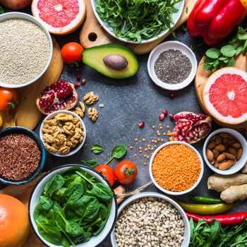 Fresh raw  ingredients for healthy cooking.  Vegetables, fruit, seeds, cereals, beans, spices, superfoods, herbs. Clean food. Top view. Diet or vegetarian food concept. Copy space