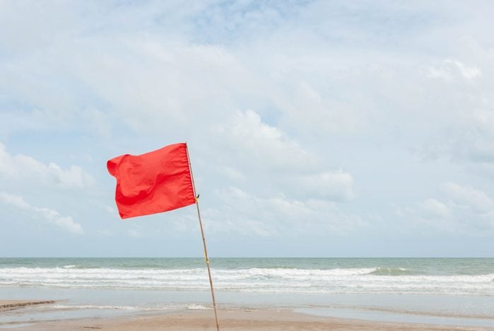Red flag warns not to play water.