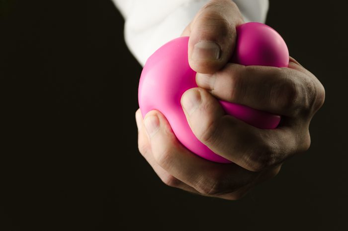 squeezing pink stress ball