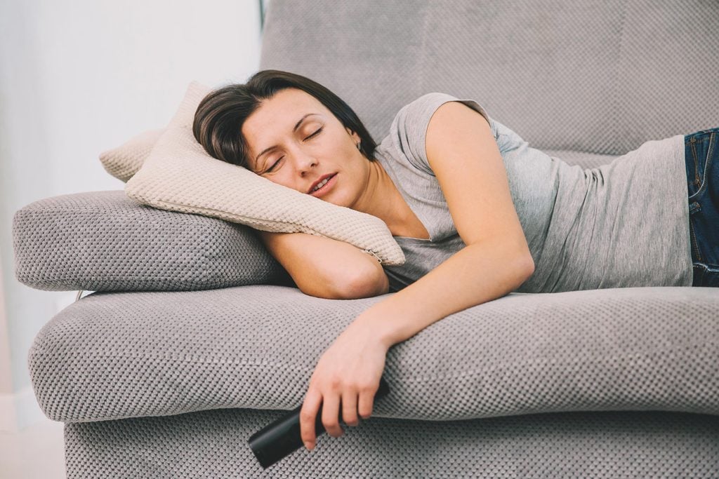 woman sleeping remote tv