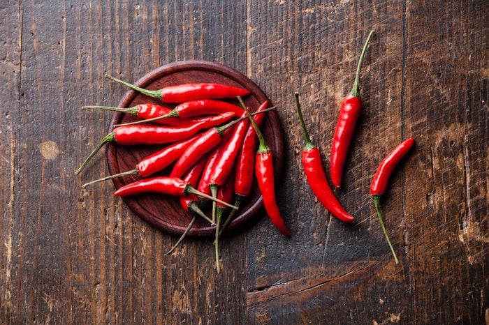 hot chili peppers on wooden background