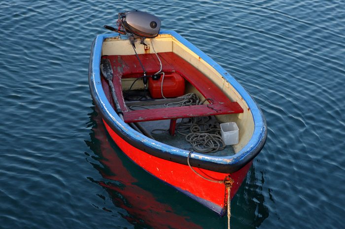 A small red boat at dusk.