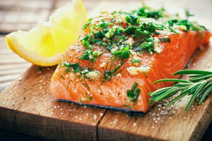 Delicious salmon on cutting board with lemon