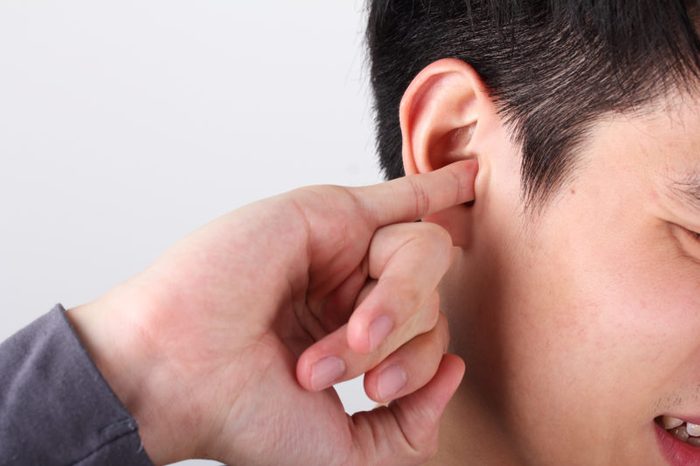 man use finger to scratching ear