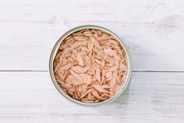 Canned tuna on wooden table
