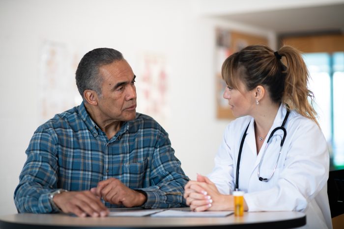 female doctor talking with male patient