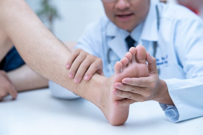 doctor examining patient's foot