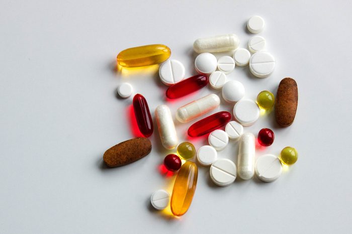 Background of assorted pharmaceutical capsules and medication in different colors, copy space