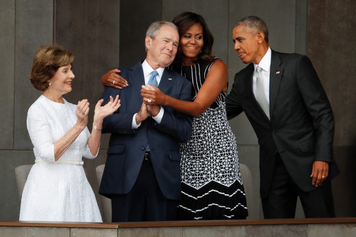 Barack Obama, Michelle Obama, Laura Bush. First lady Michelle Obama, center, hugs former President George W. Bush