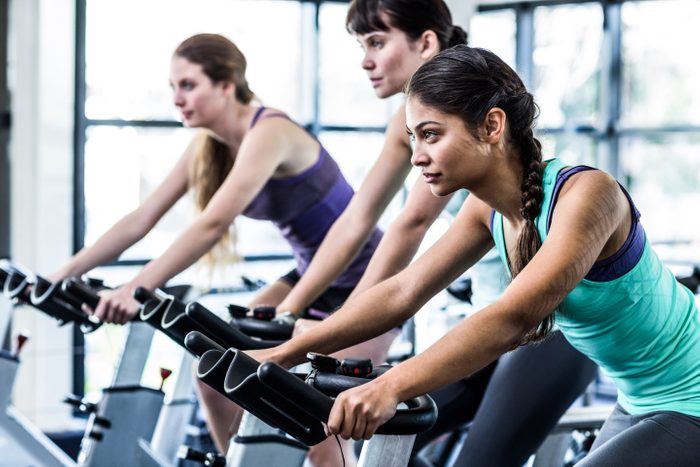 fitness class gym exercise bike diverse women