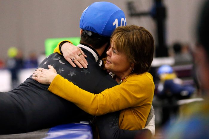 John-Henry Krueger receives a hug from his mother Heidi Krueger speedskating