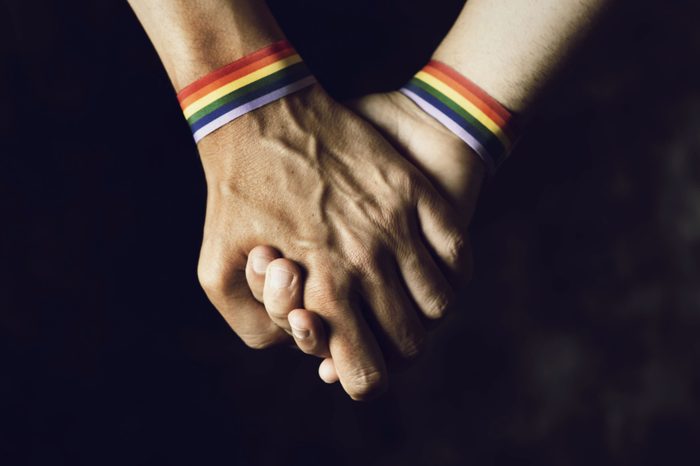 sexual orientation gay pride flag bracelets holding hands