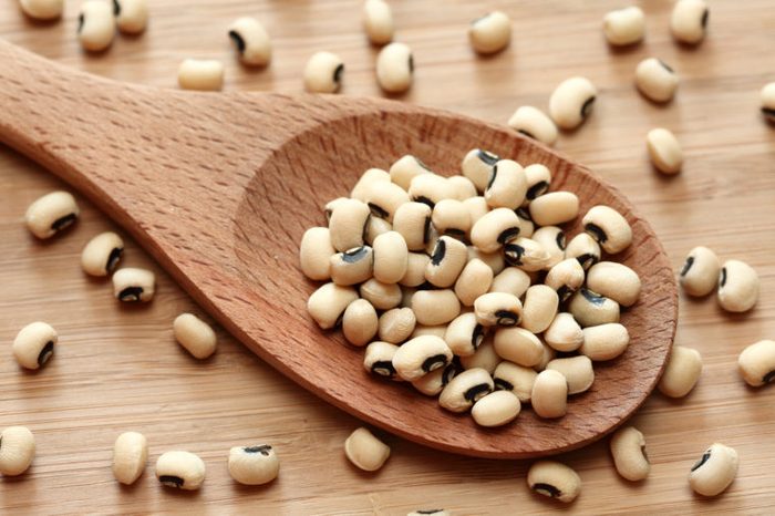 Black eyed peas in a wooden spoon. Close-up.