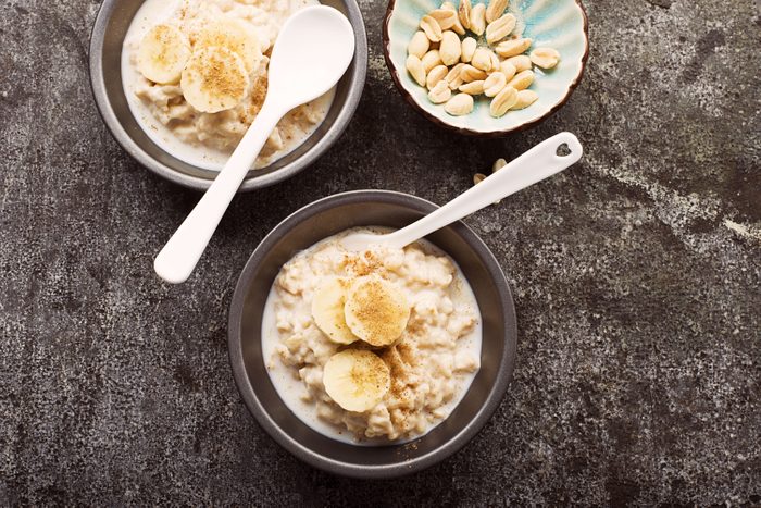 oatmeal and bananas in bowls with spoons
