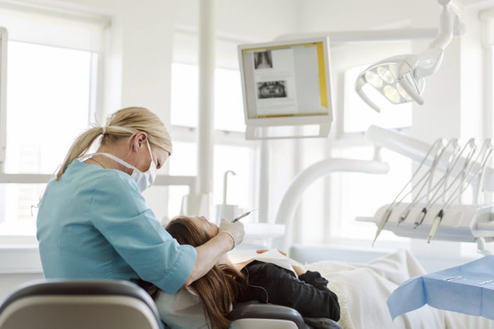 dentist performing procedure on patient