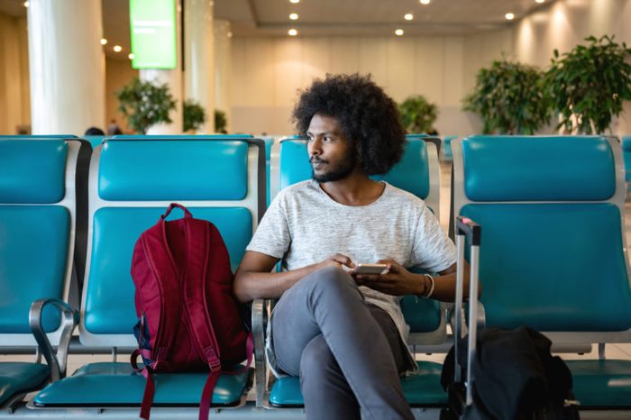 man sitting in airport traveling
