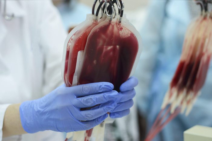 doctor handling blood donation bags in hospital