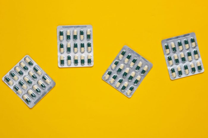pill packs on yellow background