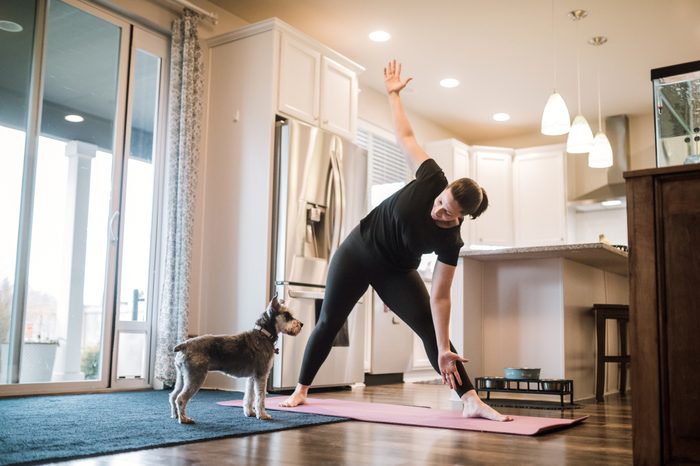 woman doing yoga in her house