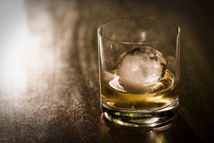 close of glass of alcohol with ice