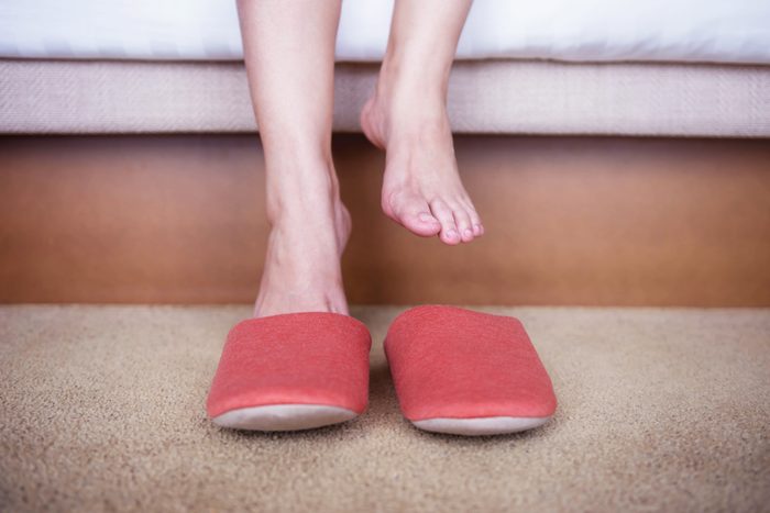 close up of woman putting on slippers