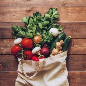 fresh produce in grocery bag overhead