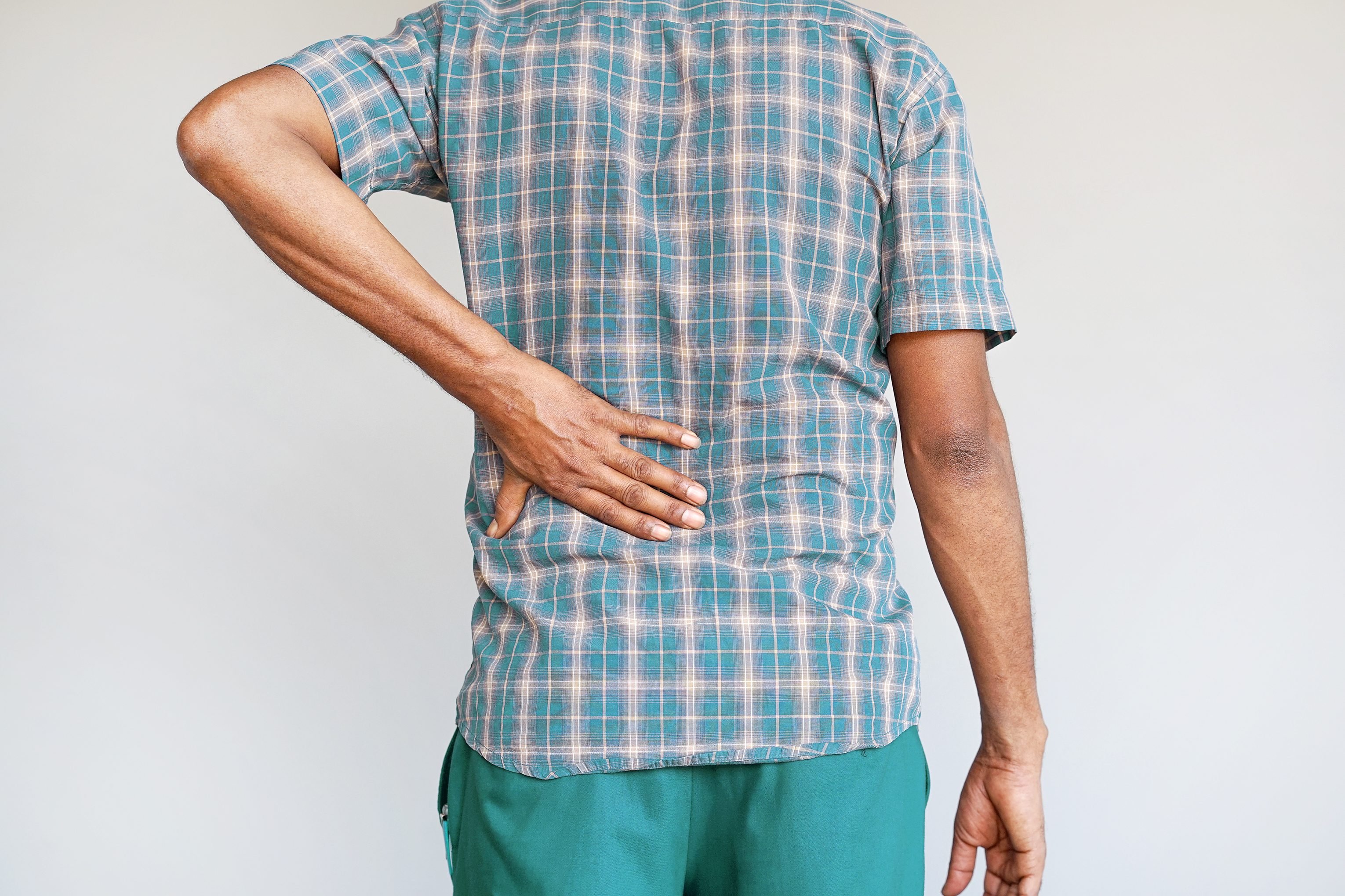 cropped shot of man with arthritis in lower back