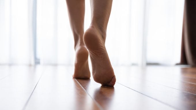 close up of woman's feet walking in home