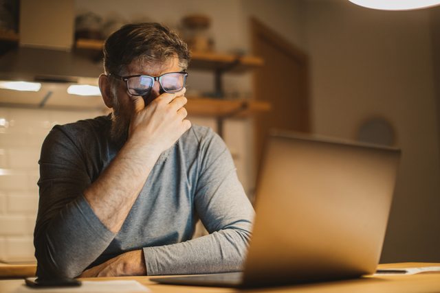 man frustrated with work at home during isolation quarantine
